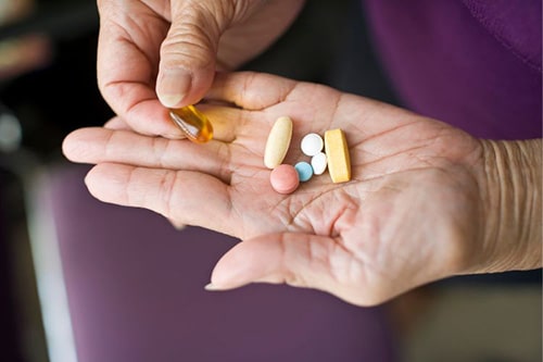 Hand holding a selection of medications